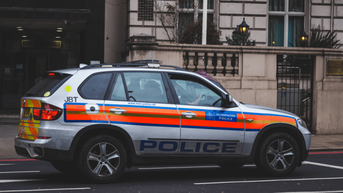 Canva - Police Car Passing by Road