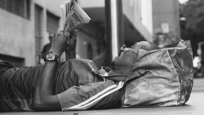 Canva - Monochrome Photo of Man Reading Newspaper
