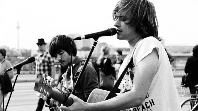 Canva - Grayscale Photo of Man Playing Singing and Playing Guitar